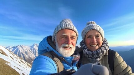 Fototapeta na wymiar Happy smile elderly couple of hikers in the ascent to the summit take a selfie phone on the snow highlands landscape around