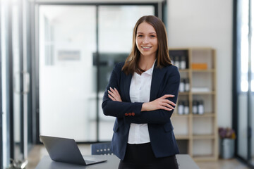 Confident Businesswoman Standing in Office with Professional Demeanor. Modern Asian Business...