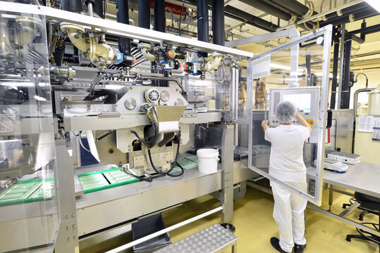 Production of pralines in a factory for the food industry - automatic conveyor belt with chocolate