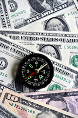 Compass and banknotes. US dollars. Navigation in the financial world.