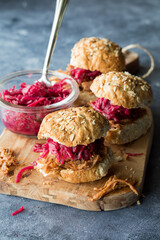Pulled pork slider buns topped with pickled red cabbage and beet sauerkraut.