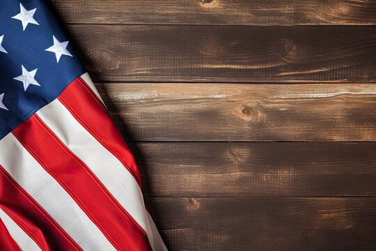 USA flag folded on wooden table background.American flag top view, copy space.Independence day template