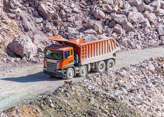 Heavy Dump Truck Rides on a Stone Quarry