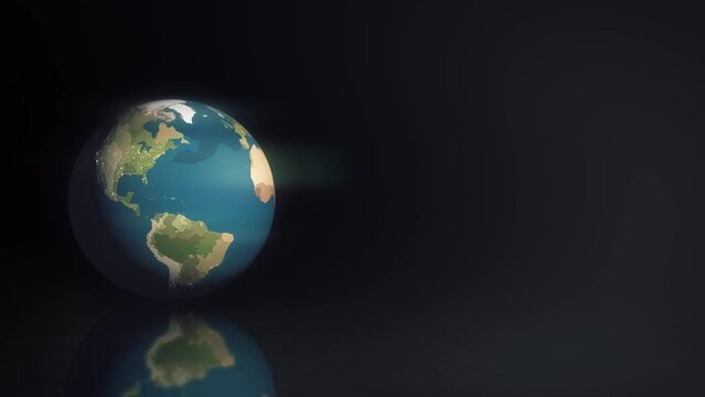 Earth ball rotates slowly on mirror black surface