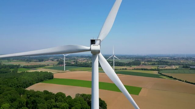 Close to the turbine. Wind turbine from aerial view - Sustainable development, environment friendly. Wind mills during bright summer day. Windmill. Agricultural fields on a summer day. . High quality