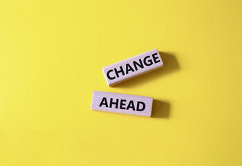 Change ahead symbol. Wooden blocks with words Change ahead. Beautiful yellow background. Business...