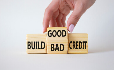 Build Good or Bad Credit symbol. Businessman hand turns wooden cubes and changes the words Build Bad Credit to Build good credit. Beautiful white background. Business concept. Copy space