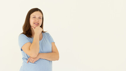 Fototapeta premium Happy successful woman standing in casual outfit, smiling pleased at camera and looking confident, standing against white background