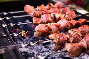 Appetizing juicy shish kebab on skewers fried on grill