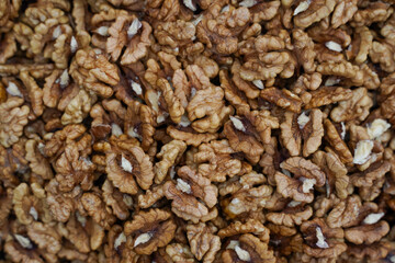Peeled walnuts. Peeled walnuts background texture. Walnut wallpaper.