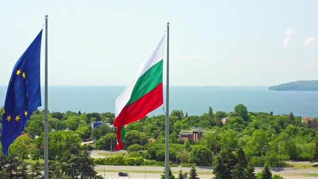 Bulgarian and European Union flags in Varna, Bulgaria isolated on blue sky and sea. Travel to Bulgaria, Entry into the Schengen area