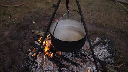 cooking on a campfire in the forest