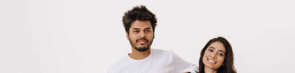 Obraz premium East asian young man and woman smiling and looking at camera