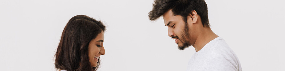 Fototapeta premium Young indian man giving present box to his girlfriend