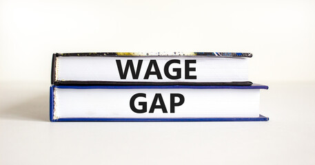 Wage gap symbol. Concept words Wage gap on beautiful books on a beautiful white table white background. Business, support and wage gap concept. Copy space.
