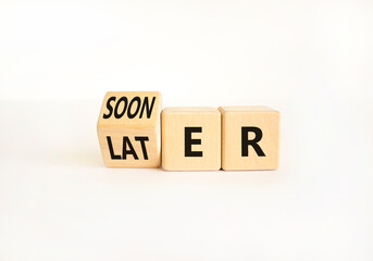 Sooner or later symbol. Businessman turns wooden cubes and changes the word Later to Sooner....