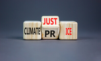 Climate justice and price symbol. Concept words Climate justice climate price on wooden cubes. Beautiful grey table grey background. Ecological climate justice and price concept. Copy space.