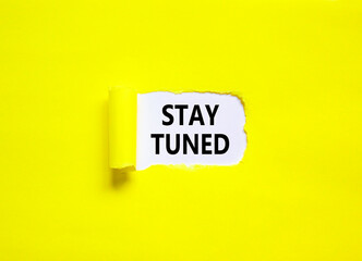 Stay tuned symbol. Concept words Stay tuned on beautiful white paper on a beautiful yellow...