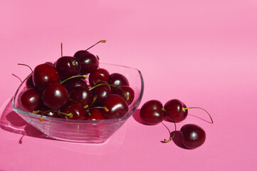 ripe cherries, juicy berries, healthy food. pink background for decoration.