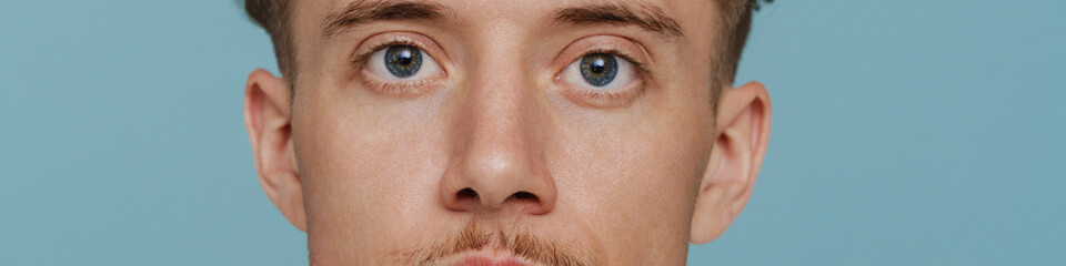 Fototapeta premium Portrait of young handsome curly calm man with mustache