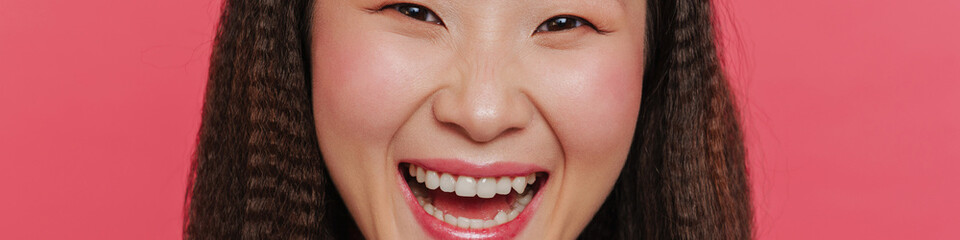 Cropped portrait of young beautiful asian girl with opened mouth