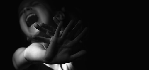 Upset young child girl craying and showing with hands STOP gesture. Blaack and white image. Copy space for text or design.