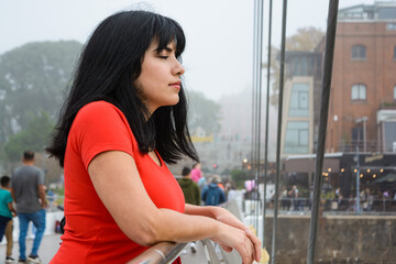 young latin woman leaning on the Puente De La Mujer in Buenos Aires calm with her eyes closed