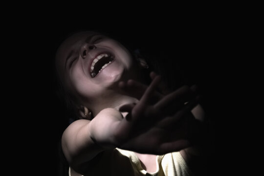 Conceptual image: Protect children and young underage people from violence, exploitation, abuse, and neglect. Upset young child girl craying and showing with hands stop gesture.