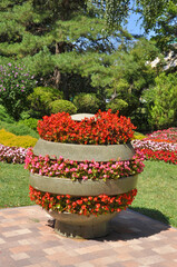 Three-tier flower pot with different flowers in the city park