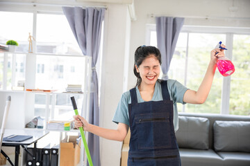 Photo of young Asian woman, housewife, general cleaning Disinfect all surfaces Woman holding mop cleaning floor standing indoors