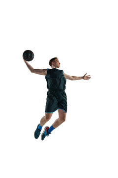 Dynamic image of sportive young man, professional basketball athelete in motion, jumping with ball isolated against white background. Concept of sport, action, health, game, hobby, sportswear, ad