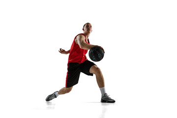 Young man, professional basketball player during game, training, running with ball isolated against...