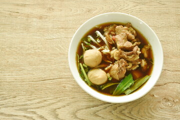 braised pork with meatball in herb brown soup on bowl 