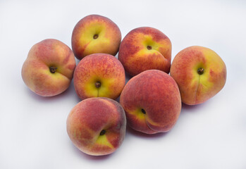 Juicy peaches on a white plate. Yellow-red large ripe peaches. Juicy fruits.