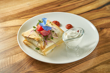 Greek fast food pita with vegetable filling and white sauce. Vegetarian fast food