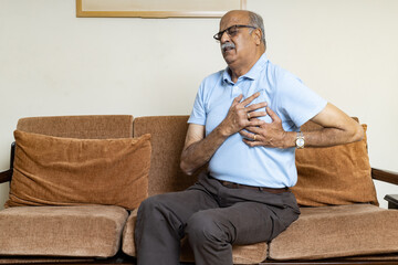 Senior Man in pain with hand on Chest due to heart attack ,