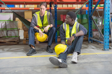 Male and female employees sit and chat.