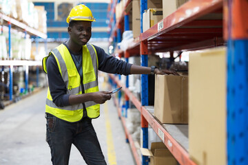 Male factory manager standing laptop.