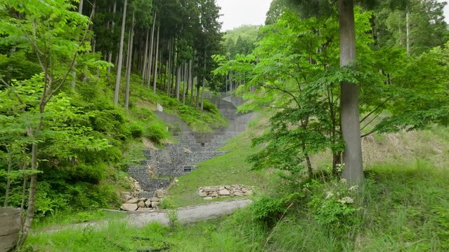 Moving fast toward rock and concrete retaining walls in forest