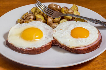 fried egg on ham  with homefries
