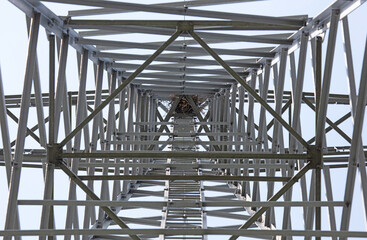 Metal electricity pole with visible bird nest