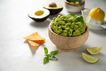 Guacamole avocado mash dip, with tortilla chips. Copy space