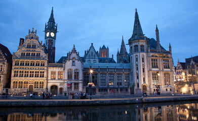 Ghent - West facade of Post palace with the canal in evening and Korenlei street 