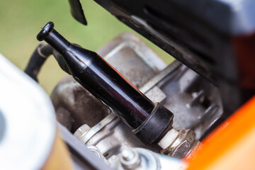 Spark plug in the engine cylinder of a walk-behind tractor. Maintenance of the ignition system....