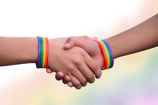 Hands which had rainbow wristbands around, LGBT symbol, concept for LGBT celebration in pride month in June around the world.