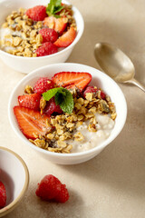 Oatmeal porridge with strawberry, homemade granola. Healthy breakfast.