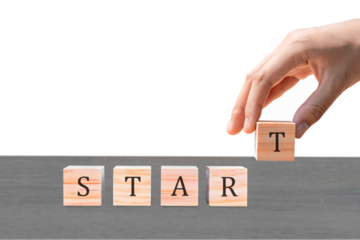 Placing a wooden block with the text "START" on a wooden table. on a white background. Business concept for a successful growth process.PNG
