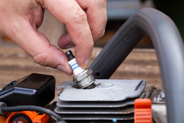 Removing the spark plug from the chainsaw cylinder. Replacing a new spark plug, a malfunction in...