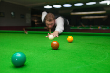 Snooker player ready for the shot. Background snooker club