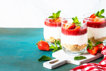 Cheesecake in a glass. Strawberry cheesecake, delicious dessert no baking in jars.